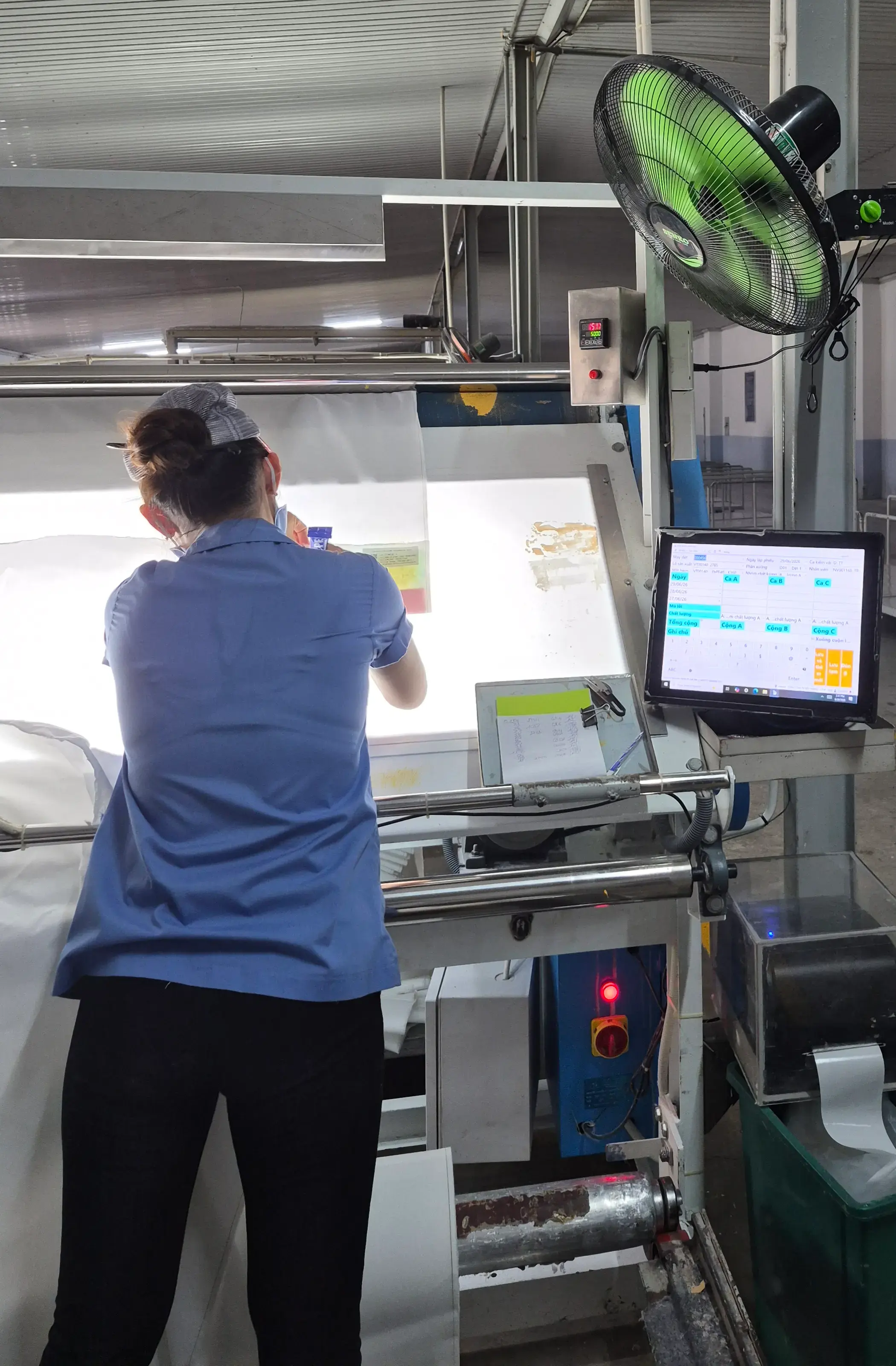 Worker inspecting quality on the production line