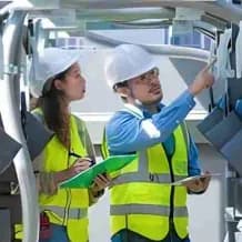 Warehouse staff checking and recording figures on the factory floor
