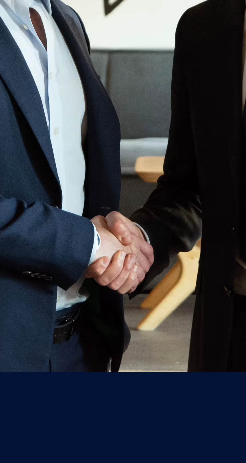 Two people shaking hands after a meeting